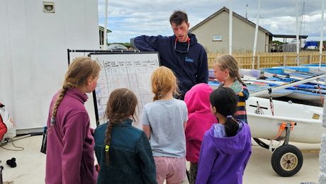 An instructor coaching from a powerboat