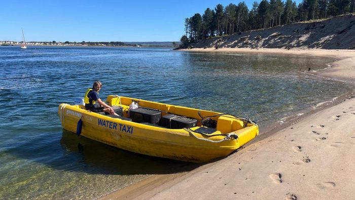 The yellow Findhorn water taxi pulled up on the beach at Culbin Sands