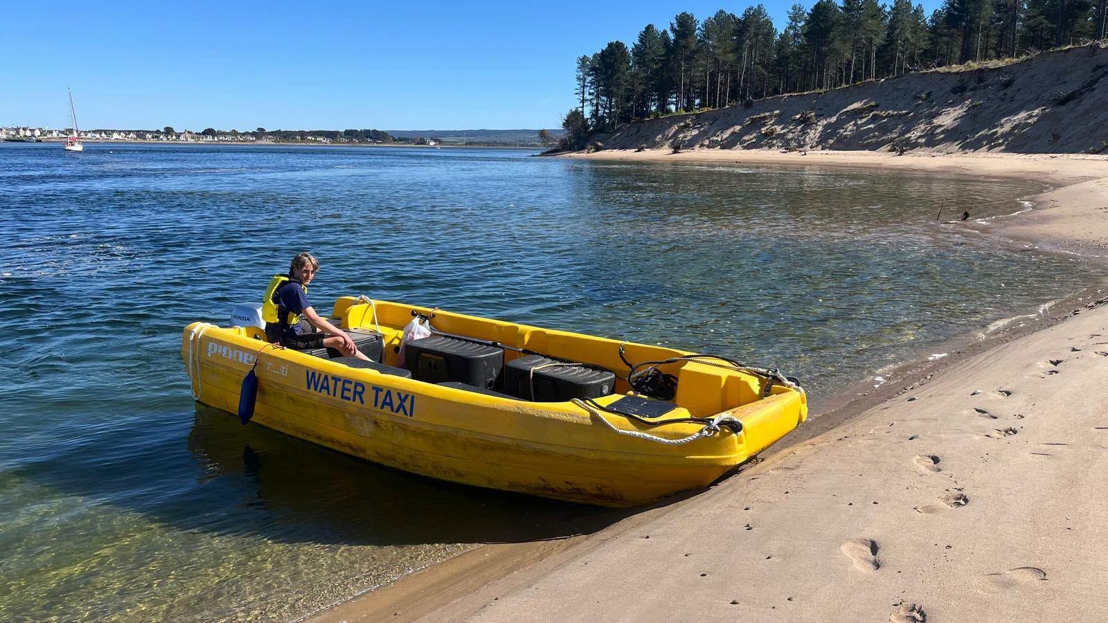 The yellow Findhorn water taxi pulled up on the beach at Culbin Sands