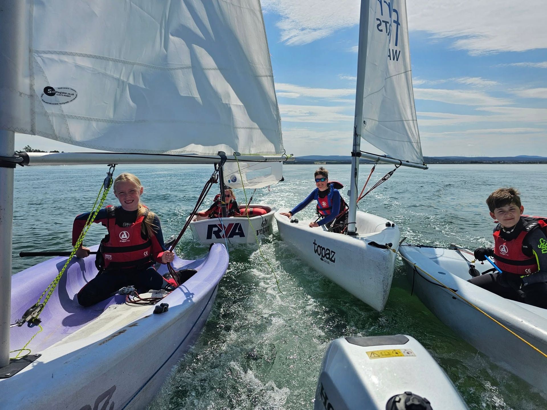Young sailors rafted together in training dinghies on Findhorn Bay