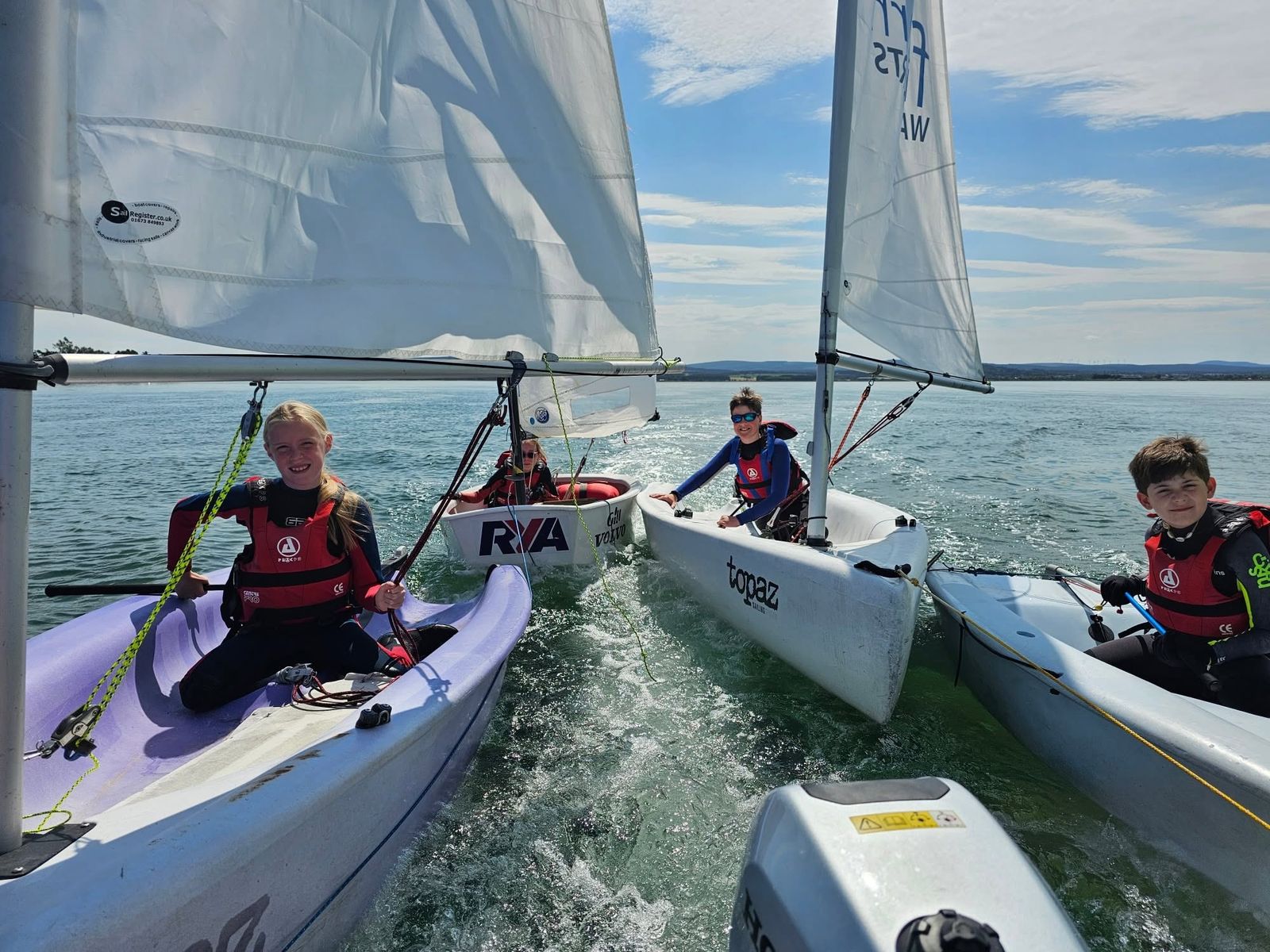 Young sailors rafted together in training dinghies
